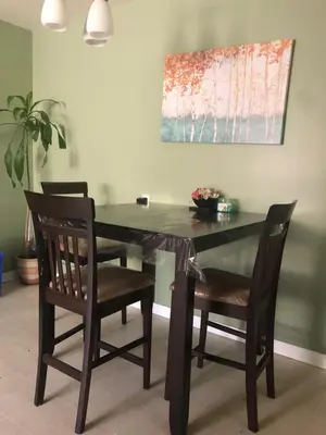 a dining room table with two chairs and a table and a painting at Private Rooms in a 3 Bedroom Guest House Close to Kingsway NAIT 1 Person per Room No Couples For Men Only in Edmonton