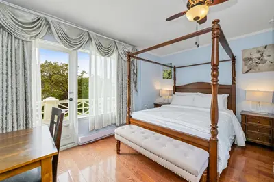 a bedroom with a bed and a table and a desk at Lipton Place by Elegant Waterfront in Victoria