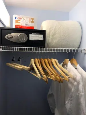 a closet with a rack of hangers and a thermometer at Lipton Place by Elegant Waterfront in Victoria