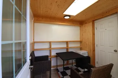 a small room with a table and chairs and a door at Lipton Place by Elegant Waterfront in Victoria