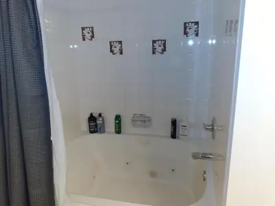 a bathroom with a shower and a bath tub with a shower at Fairmont Mountain View Villas in Fairmont Hot Springs