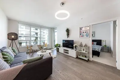 a living room with a couch and a table at UBC Pacific Spirit Modern Style Home in Vancouver