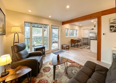 a living room with a couch and a table at Manna House in Denman Island