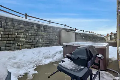a snow covered grill sitting on a patio with snow at Echo Landing #42 by Bear Country in Sun Peaks