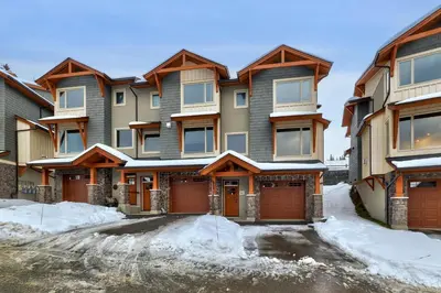 an apartment building with snow in front of it at Echo Landing #42 by Bear Country in Sun Peaks