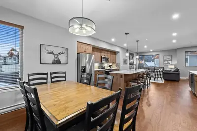 a dining room and kitchen with a table and chairs at Echo Landing #42 by Bear Country in Sun Peaks