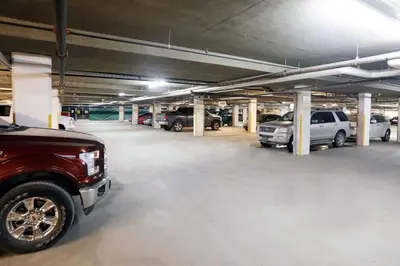 a parking garage with several cars parked in it at Top Floor Condo - 2BR & AC with Mountain Views in Canmore