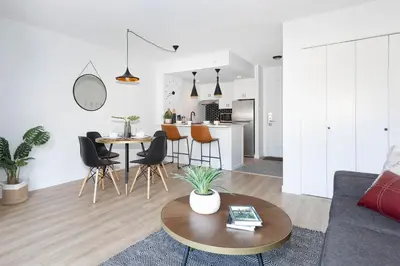 a living room and kitchen with a table and chairs at Contemporary & Spacious Slopeside 1BR Getaway in Whistler