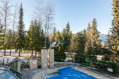 an image of a swimming pool with a hot tub at Contemporary & Spacious Slopeside 1BR Getaway in Whistler