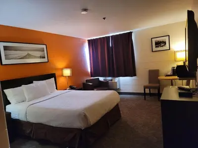 a hotel room with a bed and a desk at Roadking Inns Motel in Calgary