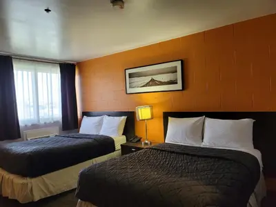 a hotel room with two beds in a room at Roadking Inns Motel in Calgary