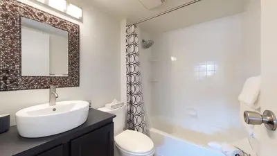 a bathroom with a sink and a toilet and a shower at 1BR and Den in Marketplace Lodge, Gas Fireplace, Village Location, Complex Hot Tub in Whistler
