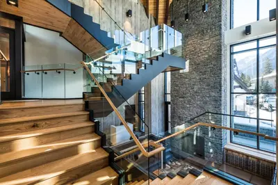a staircase in a loft with a brick wall at Peaks Hotel and Suites in Banff
