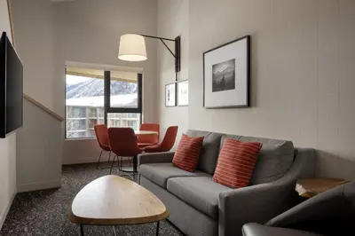a living room with a couch and a table at Peaks Hotel and Suites in Banff