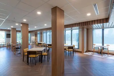 a dining room with tables and chairs and windows at Fairfield by Marriott Inn & Suites Revelstoke in Revelstoke