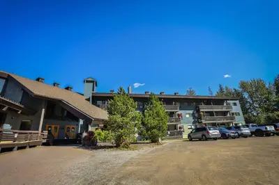 a parking lot in front of a building at Griz Inn by StayIn in Fernie