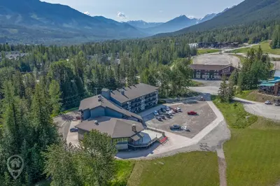an aerial view of a building in the mountains at Griz Inn by StayIn in Fernie