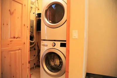 a washing machine and a washer and dryer in a room at MountainView -PrivateChalet Sleep7- 5min to DT Vacation Home in Canmore