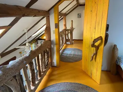 a hallway with wooden stairs in a house at Woods End Landing in Bamfield