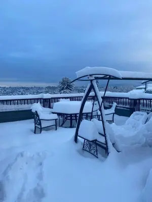 a group of benches covered in snow on a deck at Six minutes to Rupert station in Vancouver