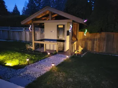 a backyard with a gazebo at night with lights at JoyVeal’s Homey Place in Sechelt