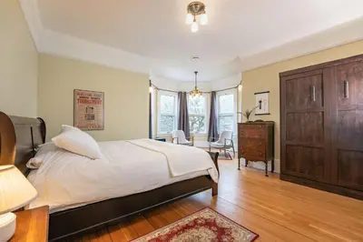 a bedroom with a bed and a dresser and a desk at The Copeland in Revelstoke