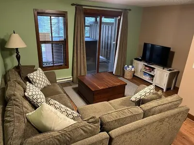 a living room with two couches and a television at Trappers Landing #34 by Bear Country in Sun Peaks