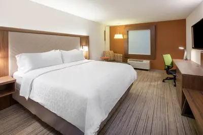 a hotel room with a large bed and a desk at Holiday Inn Express & Suites - Chilliwack East an IHG Hotel in Chilliwack