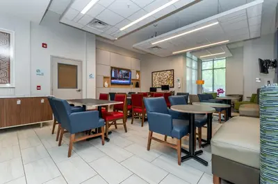 a waiting room at a hospital with tables and chairs at Holiday Inn Express & Suites - Chilliwack East an IHG Hotel in Chilliwack