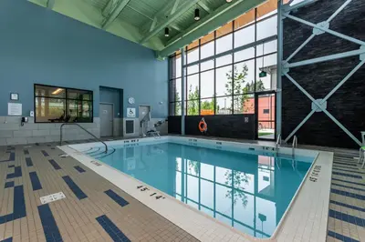 a swimming pool in a building with a large window at Holiday Inn Express & Suites - Chilliwack East an IHG Hotel in Chilliwack