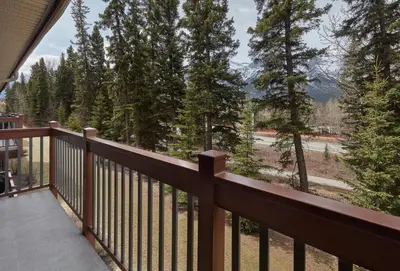 a balcony with a view of the mountains at Newly Renovated Grizzly Lodge, Spacious 3BR 2BA with open pool, hot tub in Canmore