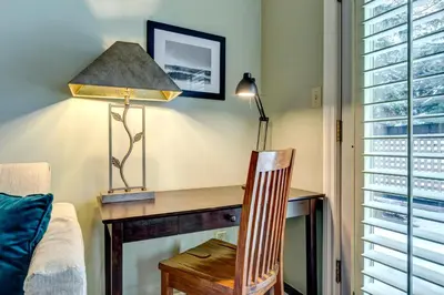 a room with a desk with a lamp and a chair at Wintergreen 27 - Townhome in Whistler