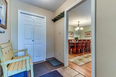 a hallway with a door leading to a dining room at Wintergreen 27 - Townhome in Whistler