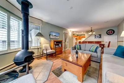 a living room with a fireplace and a couch at Wintergreen 27 - Townhome in Whistler