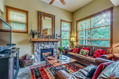 a living room with a couch and a fireplace at Mountain Star 28 Hot Tub in Whistler