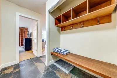 a hallway with a wooden bench in a house at Greystone Lodge 226 Ski-in Out in Whistler