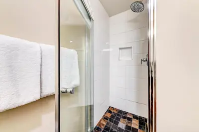 a shower with a glass door in a bathroom at Greystone Lodge 226 Ski-in Out in Whistler