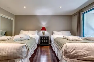 a bedroom with two beds and a window at Greystone Lodge 216 Ski-in Out in Whistler