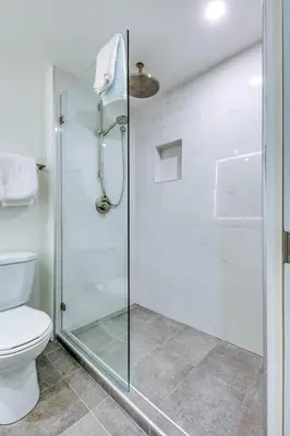 a bathroom with a glass shower with a toilet at Greystone Lodge 310 Ski-in Out in Whistler