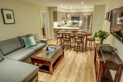 a living room with a couch and a table at Greystone Lodge 109 Ski-in Out in Whistler
