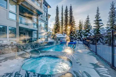 a hot tub in the backyard of a house at Greystone Lodge 109 Ski-in Out in Whistler