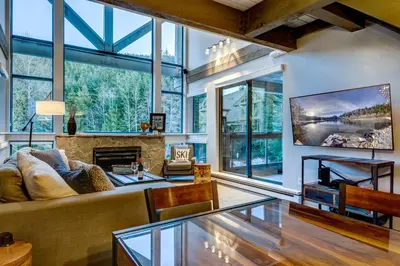 a living room with a couch and a fireplace at Greystone Lodge 412 Renovated in Whistler