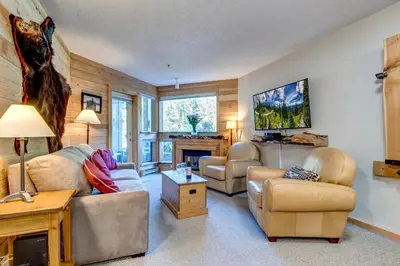 a living room with two couches and a fireplace at Greystone Lodge 229 Ski-in Out in Whistler