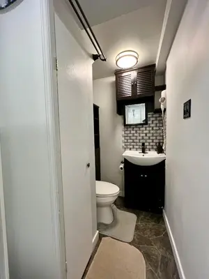 a bathroom with a toilet and a sink at Resort style home living in Delta