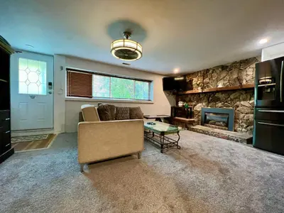 a living room with a couch and a fireplace at Resort style home living in Delta