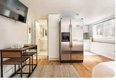 a kitchen with a stainless steel refrigerator and a table at Resort style home living in Delta
