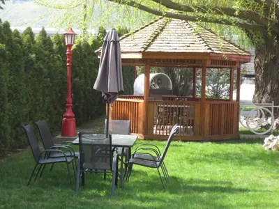 a gazebo with chairs and a table and an umbrella at Overlander Motel in Chase