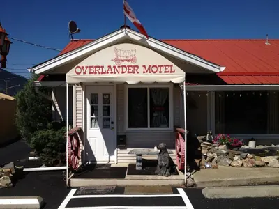 a dog sitting in front of an overlander motel at Overlander Motel in Chase