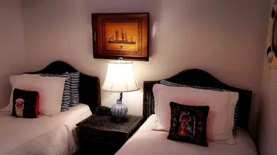 a bedroom with two beds and a lamp on a table at The Stone Hedge Bed and Breakfast in Richmond