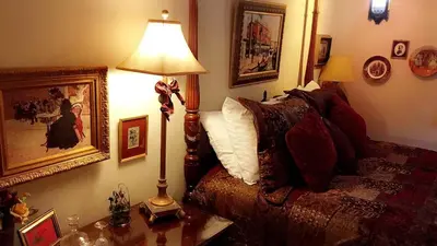 a bedroom with a bed and a lamp on a table at The Stone Hedge Bed and Breakfast in Richmond